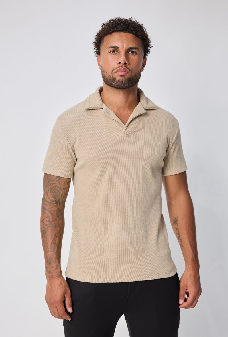 Polo uni col v à revers