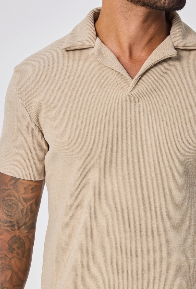 Polo uni col v à revers