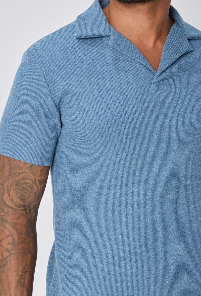 Polo uni col v à revers