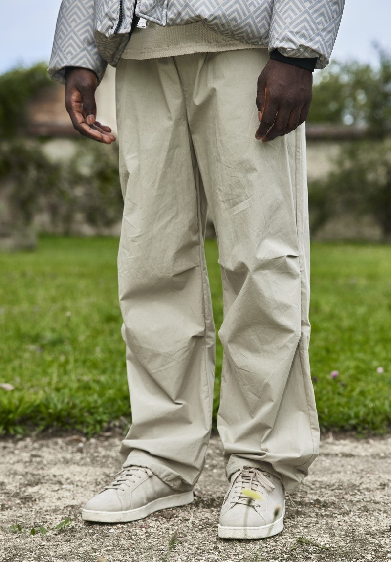 Parachute pants adjustable at the waist and ankles