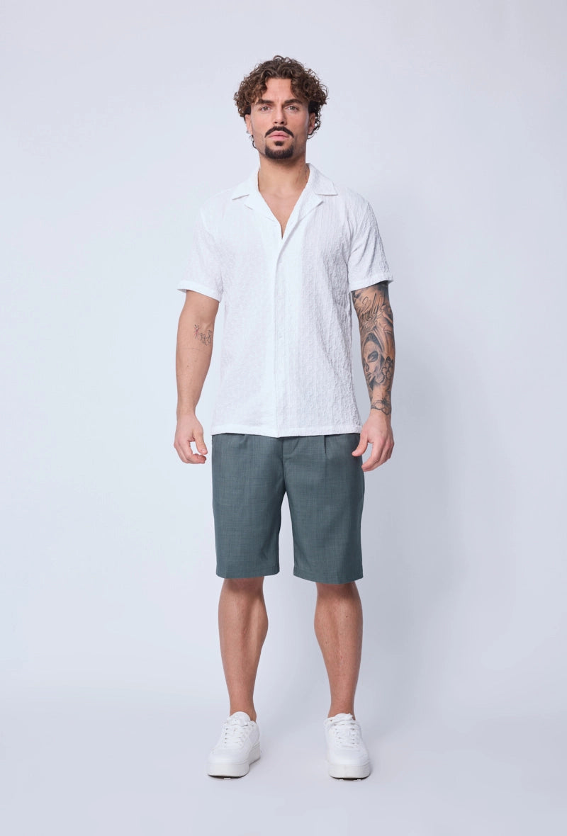 Chemise unie manches courtes à motifs géométriques