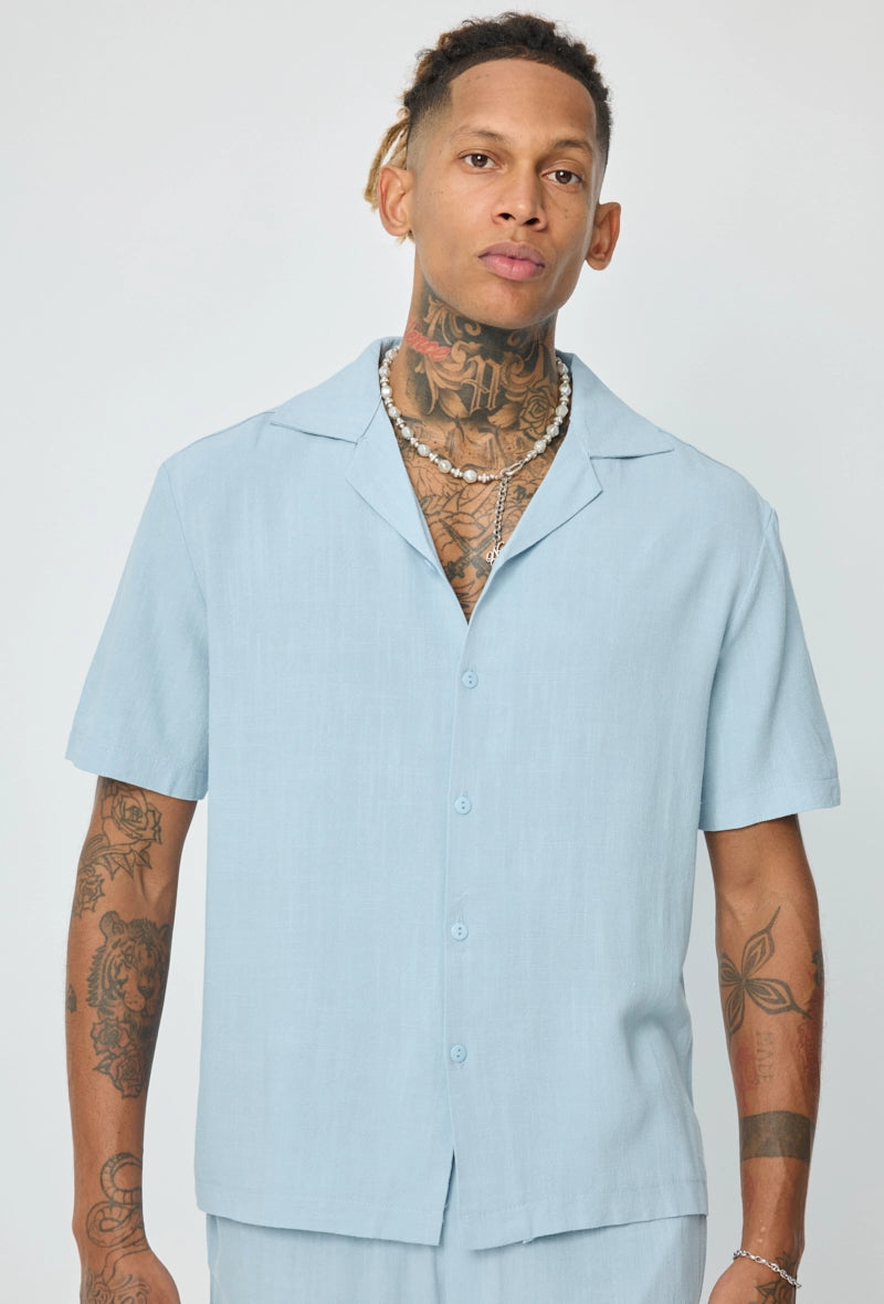 Chemise unie à boutons manches courtes