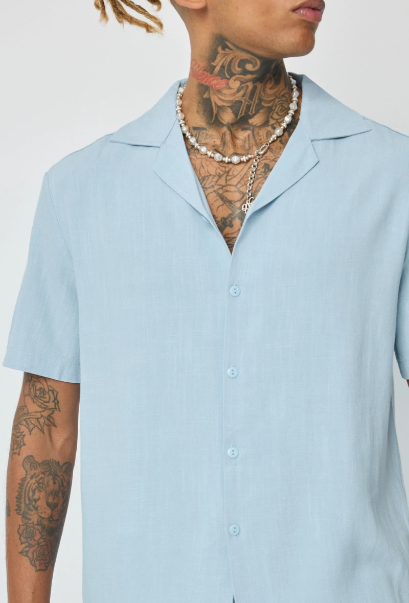 Chemise unie à boutons manches courtes