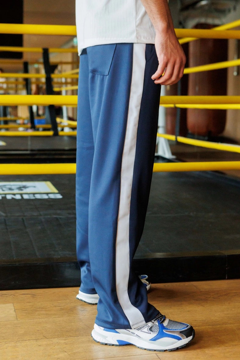 Wide jogging pants with bands along the legs