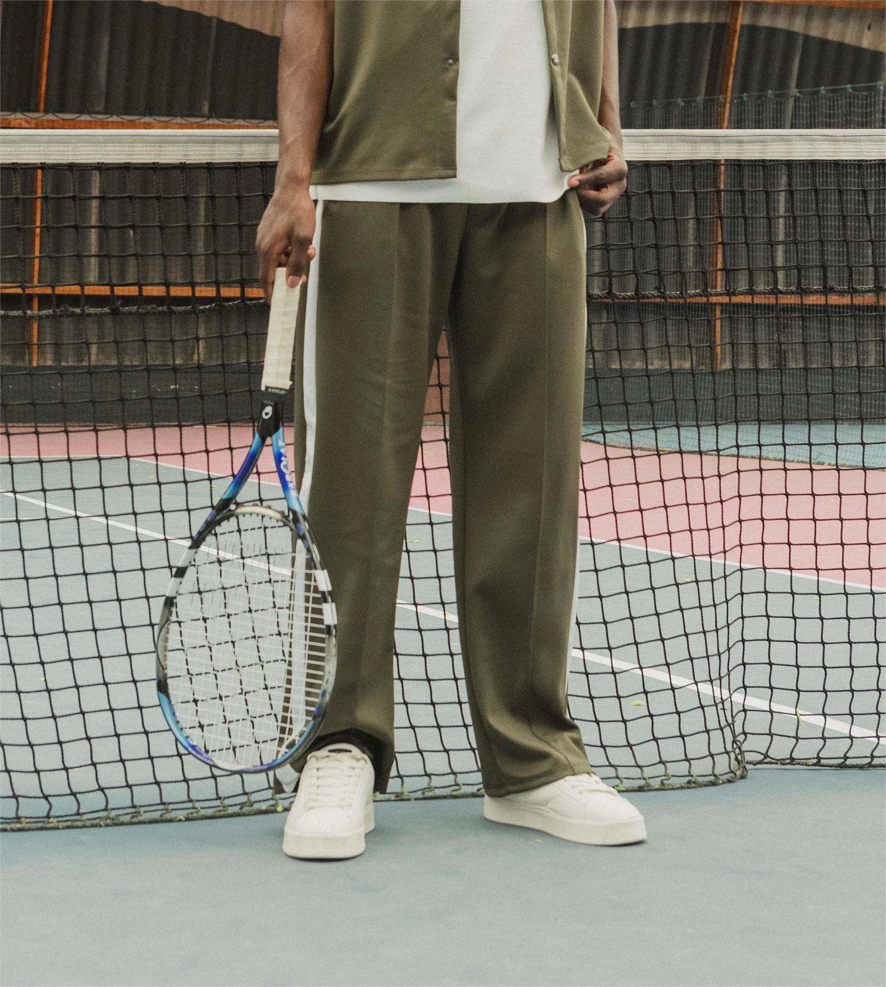 Wide jogging pants with bands along the legs