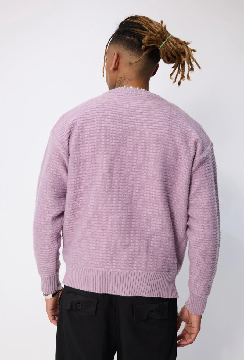 Pull uni à motif tressé